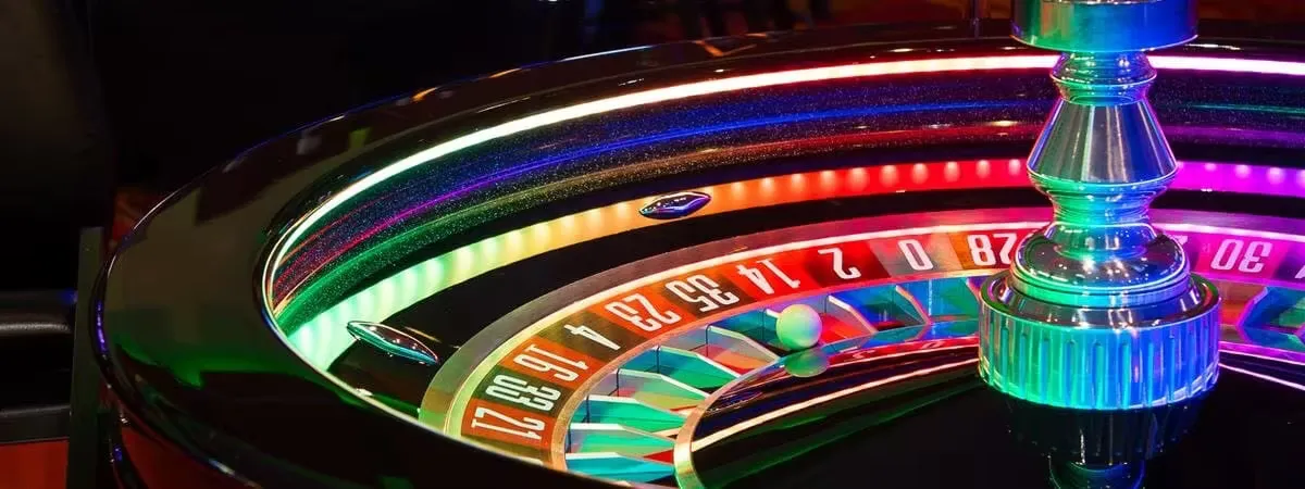 A master dealer at a high-velocity roulette podium with gilded accents — the visual hallmark of BIGPARI.
