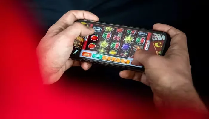 A dapper Bengali gamer scanning the massive BIGPARI mobile menu on their smartphone.